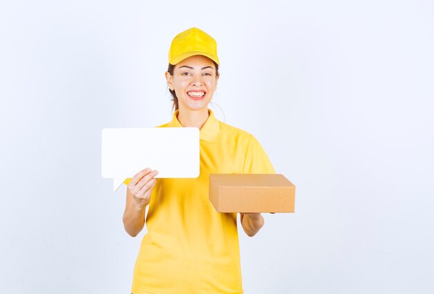 Female courier in yellow uniform offering the order to the customer and presenting the certificate of authenticity. 