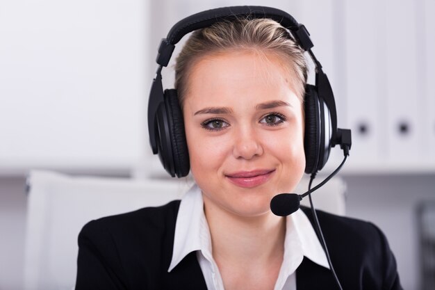 Female customer support phone operator at workplace