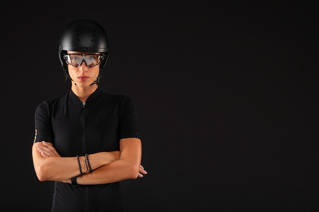 Free photo female cyclist posing with bicycle and helmet