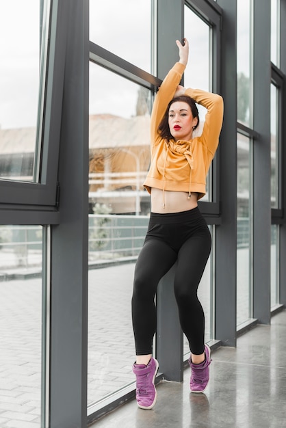 Female dance stretching near the window