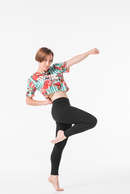 Female dancer posing against white backdrop