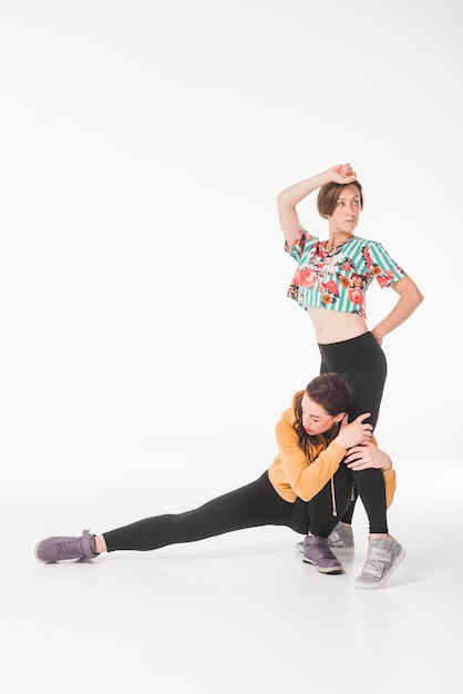 Female dancers dancing against white background