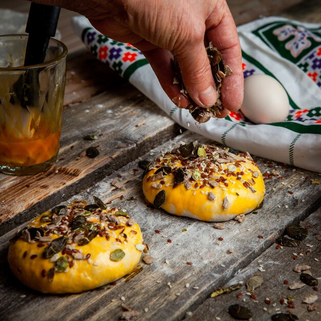 Female decorating dough with spices