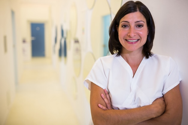 Female dentist standing with hands crossed