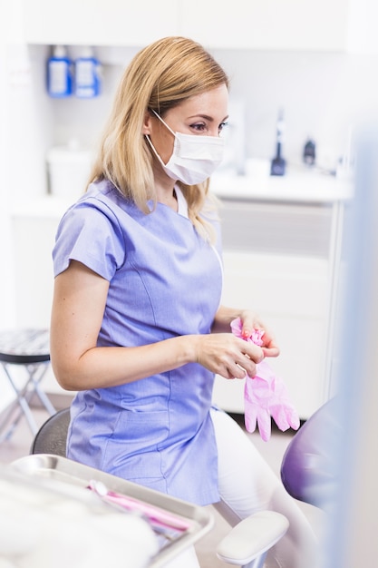 Female dentist wearing gloves in clinic