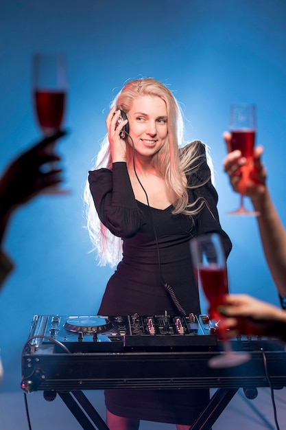 Female at dj mixing console