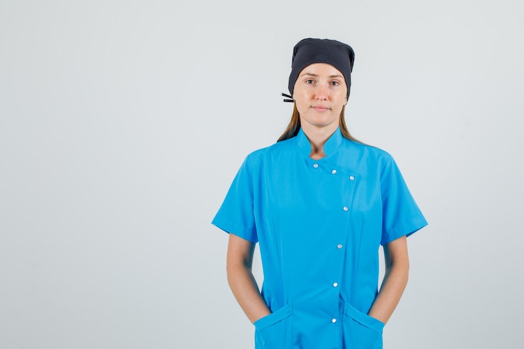 Free Photo female doctor in blue uniform, black hat holding hands in pockets and looking silent