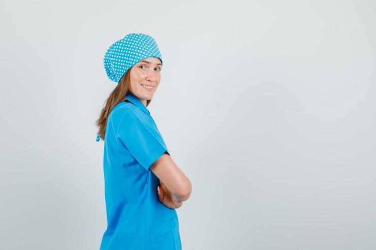 Free Photo female doctor in blue uniform standing with crossed arms and looking glad .
