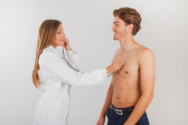 Female doctor checking patient with stethoscope