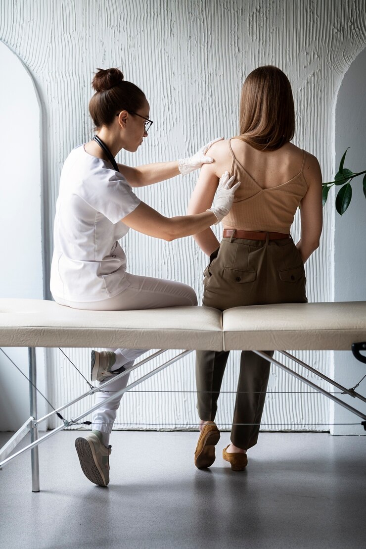 Free Photo female doctor diagnosing a melanoma on the body of a female patient