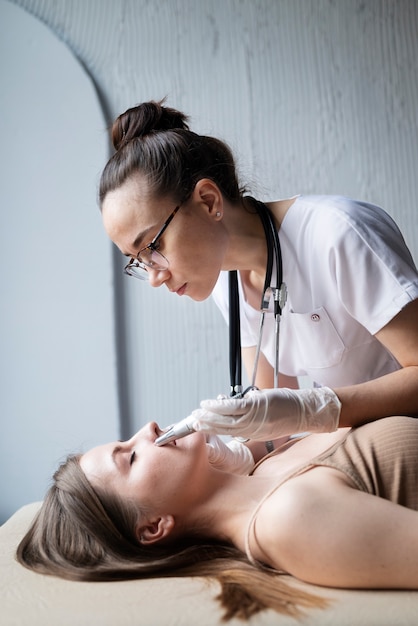 Female doctor diagnosing a melanoma on the body of a female patient