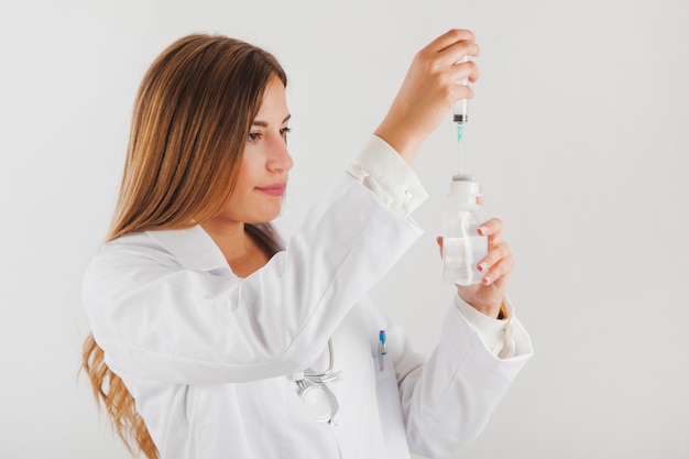 Female doctor filling up needle