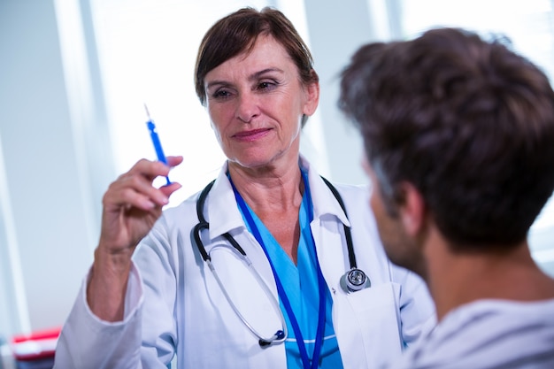 Female doctor giving an injection to a patient