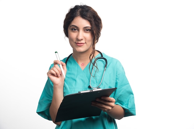 Free photo female doctor holding black clipboard in hands on white background. high quality photo