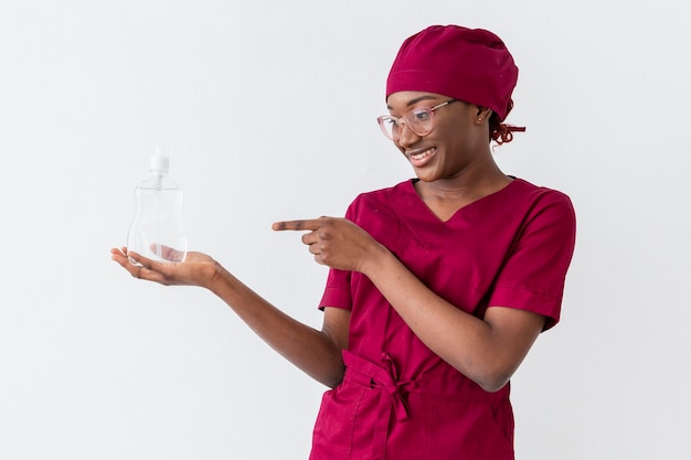 Female doctor holding liquid soap in bottle