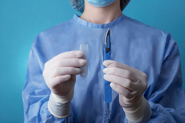 Female doctor holding metallic medical scalpel