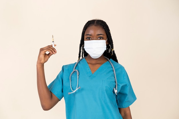 Female doctor holding syringe with vaccine