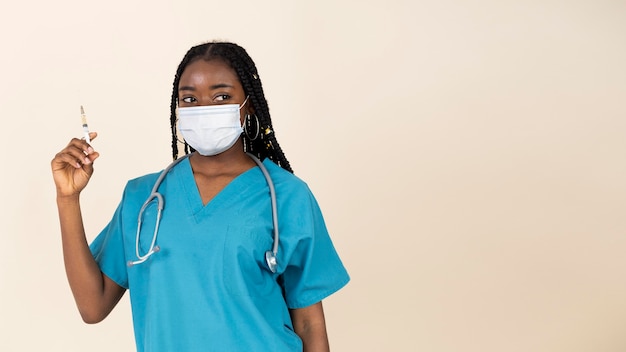 Female doctor holding syringe with vaccine