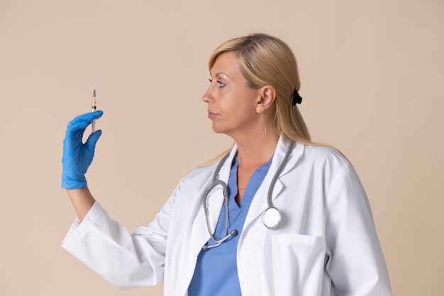 Free photo female doctor holding vaccine shot