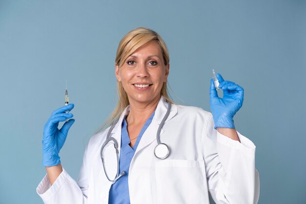 Female doctor holding vaccine shot