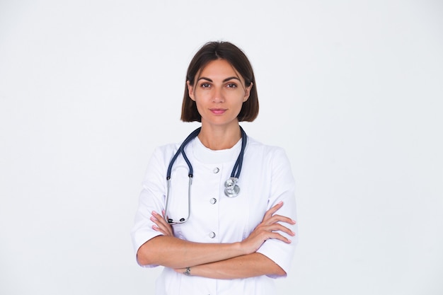 Female doctor in lab coat on white  isolated, confident smile