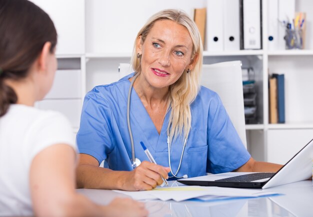 Female doctor listening to patient complaints