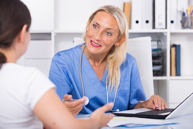 Female doctor listening to patient complaints