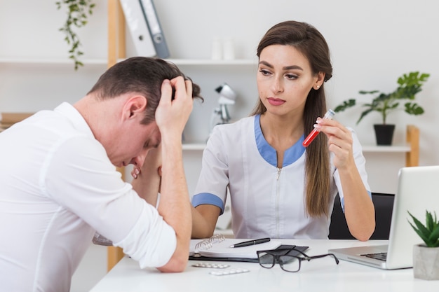 Female doctor looking at sad patient