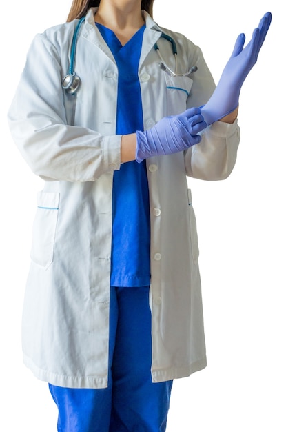 Female doctor in a medical uniform and mask putting on medical gloves getting ready for a surgery
