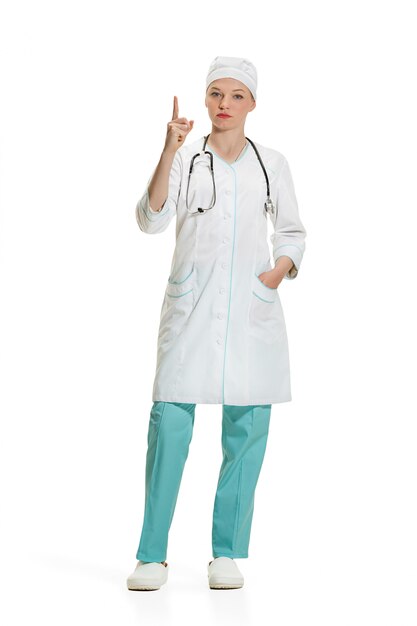 Female doctor pointing up with her finger. Health concept