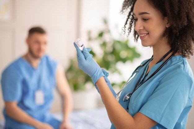 Female doctor preparing the vaccination for her colleague