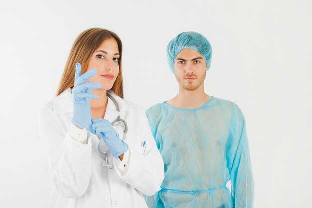 Female doctor putting on gloves