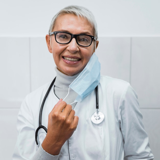 Female doctor putting on a medical mask