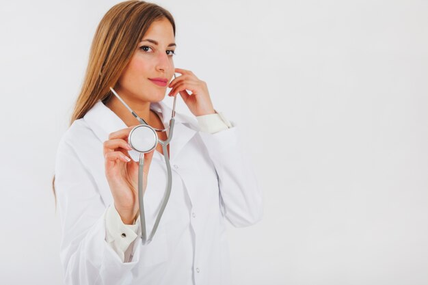 Free photo female doctor showing stethoscope