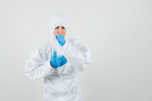 Female doctor suffering from cough in protective suit