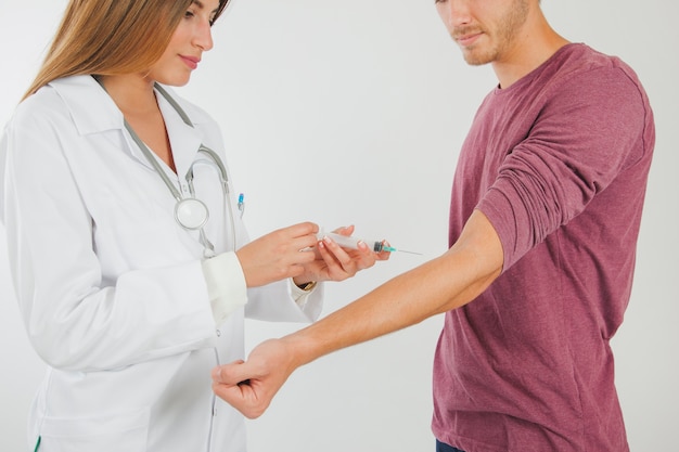 Female doctor taking blood from patient