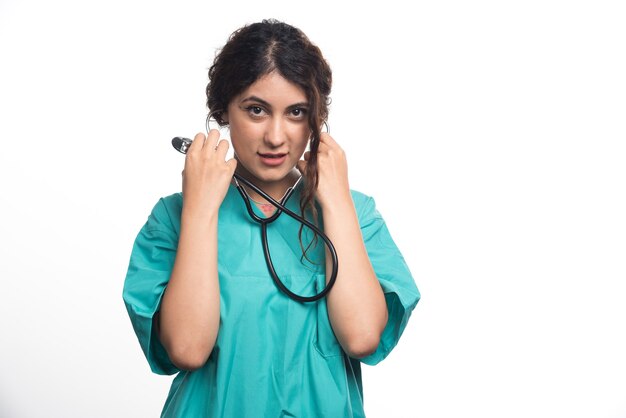 Female doctor using stethoscope on white background . High quality photo