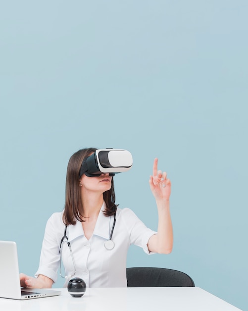 female doctor using virtual reality headset with copy space