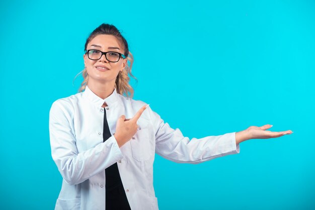 Female doctor in white uniform and eyeglasses. 