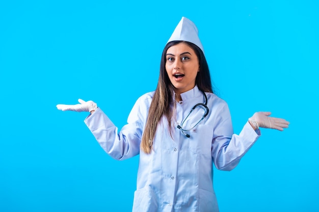 Female doctor with stethoscope doing no clue gests.