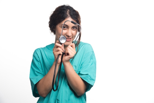 Female doctor with stethoscope on white background