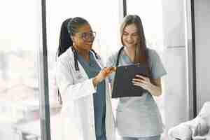 Free photo female doctors in bathrobes. african girl. stethoscope on doctor's neck.