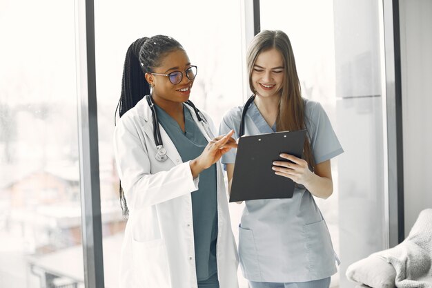 Female doctors in bathrobes. African girl. Stethoscope on doctor's neck.