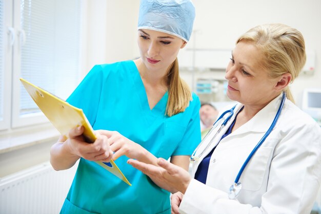 Female doctors discussing some medical records