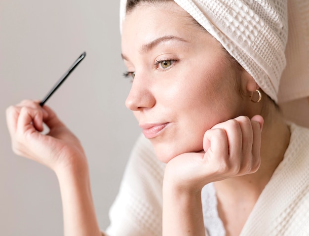 Female doing her eyebrows make up