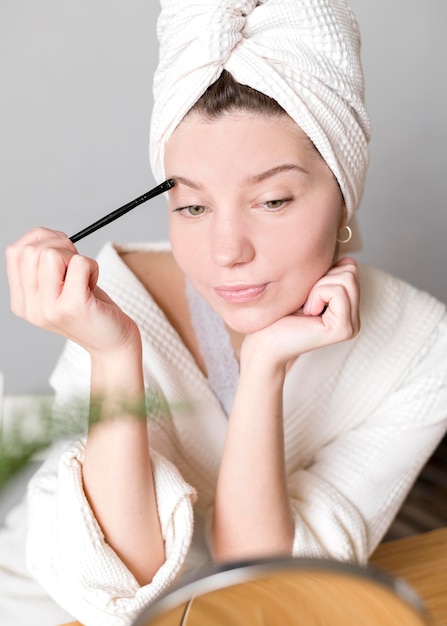 Female doing her eyebrows