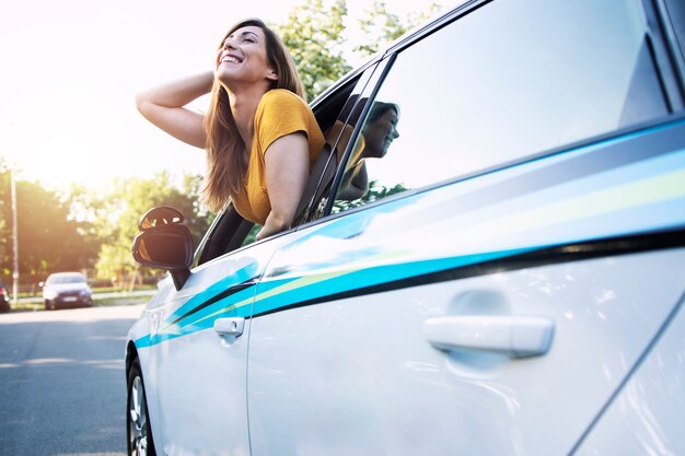 Female driver sitting in a car and looking through window