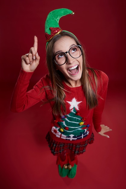 Female elf with finger up dressed in Christmas clothes
