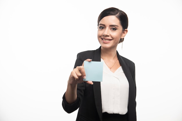 Female employee showing memo pad on white background. High quality photo