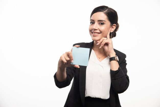 Female employee showing memo pad on white background. High quality photo